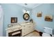 This bathroom features blue walls, granite countertops, and cabinet storage at 5991 Joseph Blake Ln, Wadmalaw Island, SC 29487