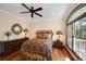 Comfortable bedroom with wood floors, ceiling fan and arched window at 5991 Joseph Blake Ln, Wadmalaw Island, SC 29487