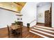 Cozy dining area with wooden table, vaulted ceilings, hardwood floors and adjacent staircase at 5991 Joseph Blake Ln, Wadmalaw Island, SC 29487