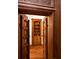 Ornate wood entryway with detailed doors leading to a room with built in shelving at 5991 Joseph Blake Ln, Wadmalaw Island, SC 29487