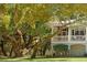Charming home with a screened-in porch, grand columns, and nestled in mature trees at 5991 Joseph Blake Ln, Wadmalaw Island, SC 29487
