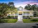 Inviting two-story traditional home featuring a covered porch and mature landscaping at 5991 Joseph Blake Ln, Wadmalaw Island, SC 29487