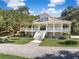 Charming two-story traditional home featuring a large wrap around porch and a beautiful lawn at 5991 Joseph Blake Ln, Wadmalaw Island, SC 29487