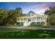 Charming two-story traditional home with a large front porch and mature trees at 5991 Joseph Blake Ln, Wadmalaw Island, SC 29487