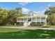 Elegant home with a large porch, offering scenic views and outdoor relaxation at 5991 Joseph Blake Ln, Wadmalaw Island, SC 29487