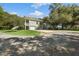 Spacious home with a three-car garage, well-manicured lawn, and mature trees at 5991 Joseph Blake Ln, Wadmalaw Island, SC 29487