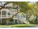 Elegant home featuring a wraparound porch, columns, and mature trees at 5991 Joseph Blake Ln, Wadmalaw Island, SC 29487