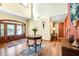 Elegant foyer with hardwood floors, soaring ceilings, and a decorative table with fresh flowers at 5991 Joseph Blake Ln, Wadmalaw Island, SC 29487