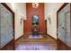 Stunning home foyer featuring hardwood floors, tall ceilings, decorative lighting, and a patterned rug at 5991 Joseph Blake Ln, Wadmalaw Island, SC 29487