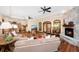 Spacious living room featuring hardwood floors, a stone fireplace, and ceiling fans at 5991 Joseph Blake Ln, Wadmalaw Island, SC 29487