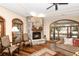 Cozy living room with a stone fireplace and hardwood floors at 5991 Joseph Blake Ln, Wadmalaw Island, SC 29487