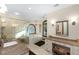 This bathroom features a glass shower, soaking tub, vanity, and elegant chandelier at 5991 Joseph Blake Ln, Wadmalaw Island, SC 29487
