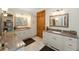 This spacious bathroom features double sinks, granite countertops, and cabinet storage at 5991 Joseph Blake Ln, Wadmalaw Island, SC 29487