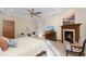 This main bedroom has a fireplace, wood details, and neutral colors at 5991 Joseph Blake Ln, Wadmalaw Island, SC 29487