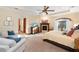 Spacious primary bedroom with a fireplace, sitting area, and large windows at 5991 Joseph Blake Ln, Wadmalaw Island, SC 29487