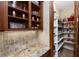 Walk-in pantry featuring granite counters, custom shelving and plenty of storage at 5991 Joseph Blake Ln, Wadmalaw Island, SC 29487