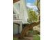 Inviting porch with classic white columns and railing, surrounded by mature trees at 5991 Joseph Blake Ln, Wadmalaw Island, SC 29487