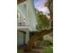 Inviting porch with classic white columns and railing, surrounded by mature trees at 5991 Joseph Blake Ln, Wadmalaw Island, SC 29487