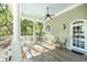 Covered porch with ceiling fan and seating area at 5991 Joseph Blake Ln, Wadmalaw Island, SC 29487