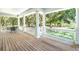 Porch with columns and seating area overlooking the grounds at 5991 Joseph Blake Ln, Wadmalaw Island, SC 29487
