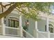 Charming porch with decorative lighting, complemented by lush green plants and white railings at 5991 Joseph Blake Ln, Wadmalaw Island, SC 29487
