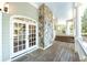 Covered porch with stone pillar and views of the outdoors at 5991 Joseph Blake Ln, Wadmalaw Island, SC 29487