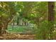 Secluded property with a wooden fence, surrounded by lush greenery and trees at 5991 Joseph Blake Ln, Wadmalaw Island, SC 29487