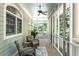 Relaxing screened-in porch with comfortable seating, wood floors, and views of the serene outdoor landscape at 5991 Joseph Blake Ln, Wadmalaw Island, SC 29487