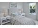 Bright bedroom with plush carpeting, large windows, and a queen-size bed with decorative pillows at 605 Red Monarch Way, Moncks Corner, SC 29461