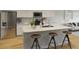 Well-equipped kitchen featuring stainless steel appliances, white cabinets, and a spacious island with bar stool seating at 605 Red Monarch Way, Moncks Corner, SC 29461