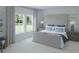 Luxurious Primary bedroom with large windows, soft carpet, a king bed, and contemporary decor at 605 Red Monarch Way, Moncks Corner, SC 29461