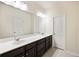 Bathroom vanity with double sinks, dark cabinets, white countertops, and a large mirror at 612 Mclernon Trce, Johns Island, SC 29455