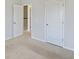 Bedroom with gray walls and carpet with a closed white door and an open door at 612 Mclernon Trce, Johns Island, SC 29455