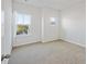 Bedroom with neutral walls, carpet, and two windows with white curtains at 612 Mclernon Trce, Johns Island, SC 29455