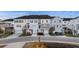 Exterior view of townhomes with front-facing garages and manicured lawns at 612 Mclernon Trce, Johns Island, SC 29455