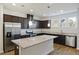 Well-appointed kitchen with a granite island, stainless steel appliances, and rich, dark wood cabinets at 612 Mclernon Trce, Johns Island, SC 29455