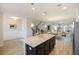 Open concept: kitchen with granite island, stainless appliances, and a view of dining and living areas at 612 Mclernon Trce, Johns Island, SC 29455