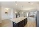 Open concept: kitchen with granite island, stainless appliances, and a view of dining and living areas at 612 Mclernon Trce, Johns Island, SC 29455
