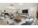 Open concept living room with stairs, kitchen view, and hardwood floors at 612 Mclernon Trce, Johns Island, SC 29455