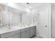 Bathroom with a double sink vanity, sleek gray cabinets, a large mirror, and plenty of counter space for a clean aesthetic at 615 Red Monarch Way, Moncks Corner, SC 29461