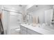 Clean bathroom featuring a shower over tub, a large mirror, neutral decor, and a spacious vanity top at 615 Red Monarch Way, Moncks Corner, SC 29461