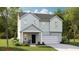 Charming two-story home with a front porch, attached garage, well-manicured lawn, and appealing curb appeal at 615 Red Monarch Way, Moncks Corner, SC 29461