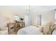 Relaxing main bedroom suite with serene decor, a dresser with a decorative mirror, and a comfortable armchair in neutral tones at 615 Red Monarch Way, Moncks Corner, SC 29461