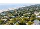 Picturesque aerial shot of a beachfront neighborhood, showcasing beautiful homes nestled among trees with ocean views at 619 E Erie Ave, Folly Beach, SC 29439