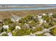 Charming neighborhood surrounded by lush green trees and a beautiful waterway in a serene coastal setting at 619 E Erie Ave, Folly Beach, SC 29439