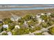 A scenic view shows a cozy neighborhood nestled among lush trees near tranquil marshlands and waterways at 619 E Erie Ave, Folly Beach, SC 29439