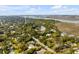 Breathtaking aerial view of a charming coastal community, with lush greenery, waterfront access, and a distant bridge at 619 E Erie Ave, Folly Beach, SC 29439