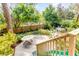 Overhead view of a tiered wooden deck surrounded by a lush, green yard with table and slide at 619 E Erie Ave, Folly Beach, SC 29439