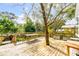 Spacious wooden deck featuring built-in planters and a beautiful tree at 619 E Erie Ave, Folly Beach, SC 29439