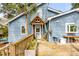 Backyard deck with a blue home, potted plants and view of the front yard at 619 E Erie Ave, Folly Beach, SC 29439